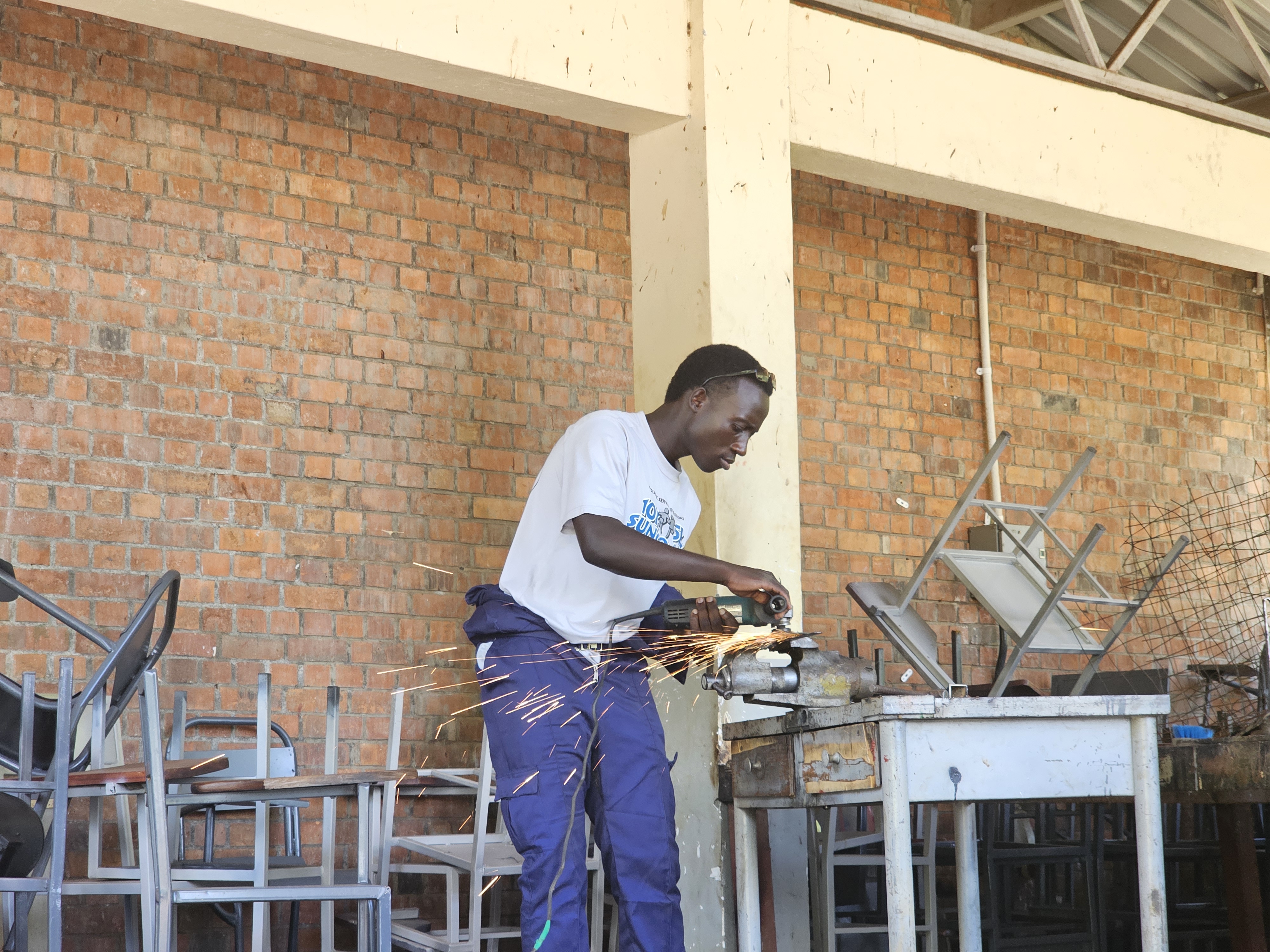 A Busitema University student carrying out metalwork during a practical session in the campus workshop.