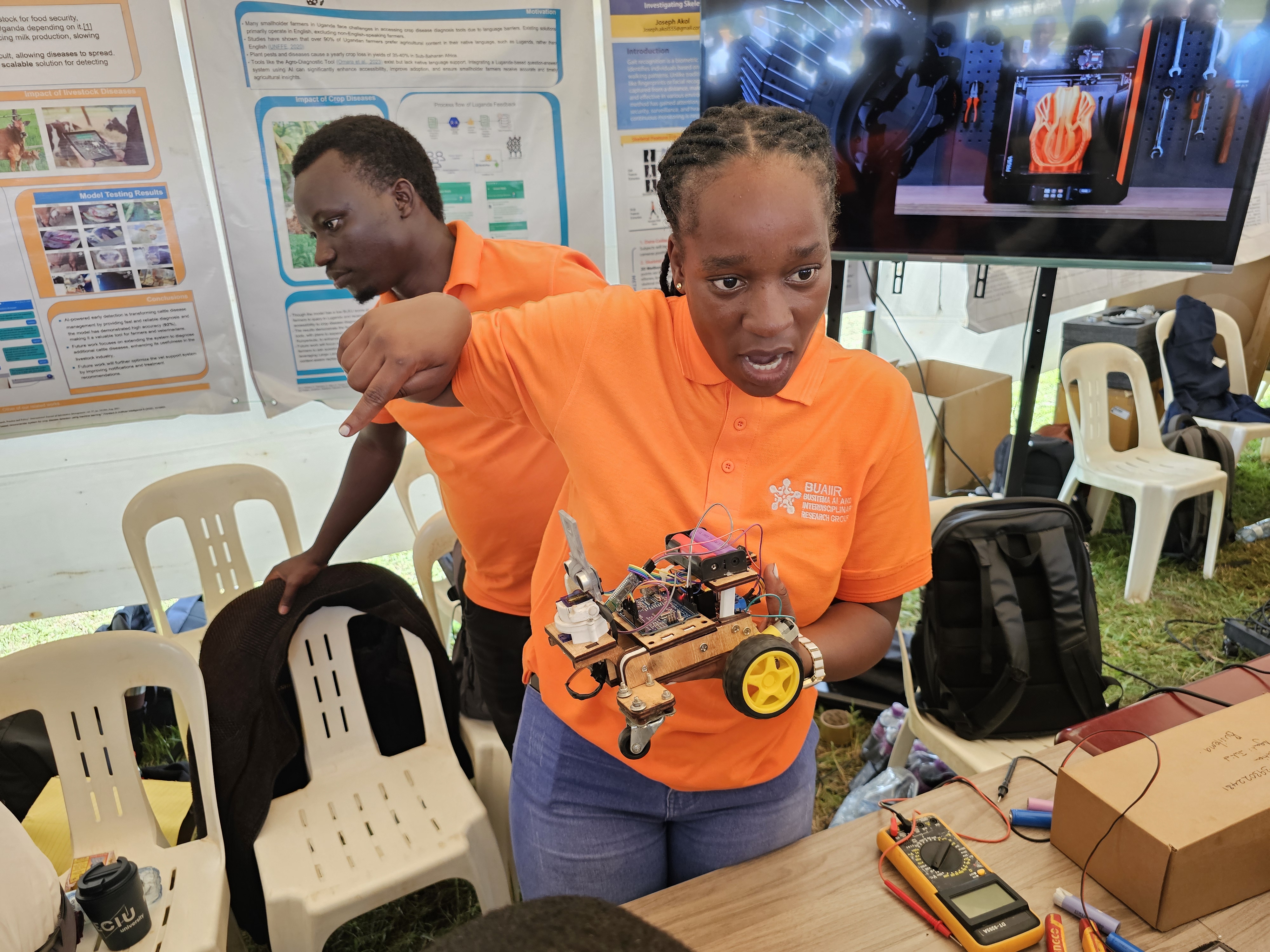 A Busitema University student demonstrates a robotic prototype during a research and innovation exhibition.