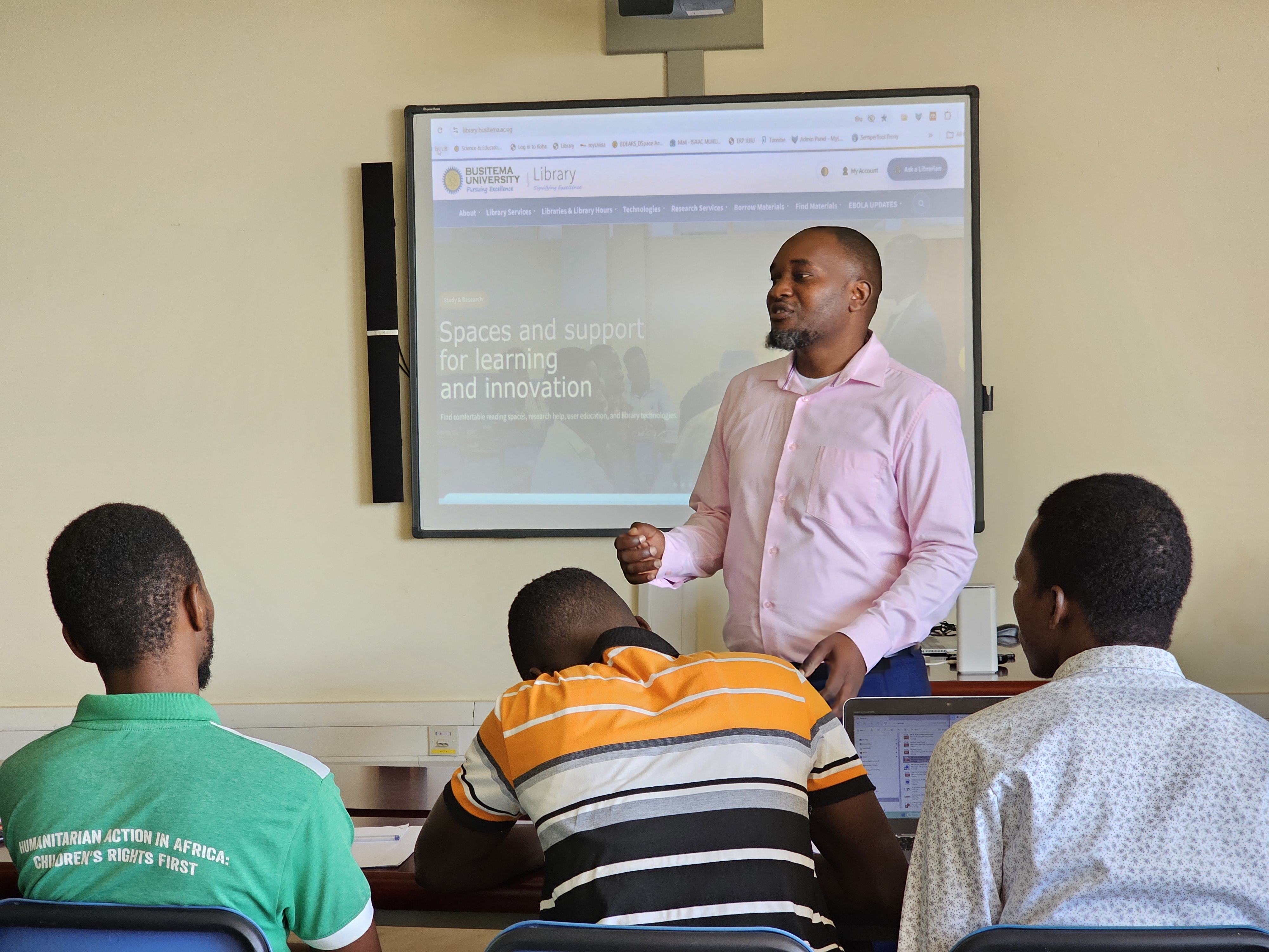 A library staff member guides students through Busitema University Library’s online services and digital learning resources